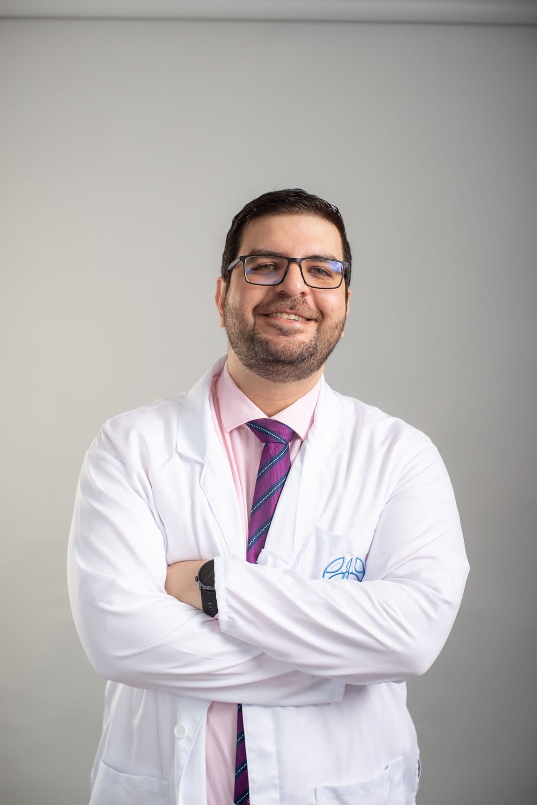 El Dr. Osama Bahsas Zaky, cirujano oncólogo, con bata blanca y los brazos cruzados